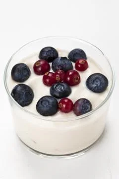 Yogurt in plastic box container over white background Stock Photos