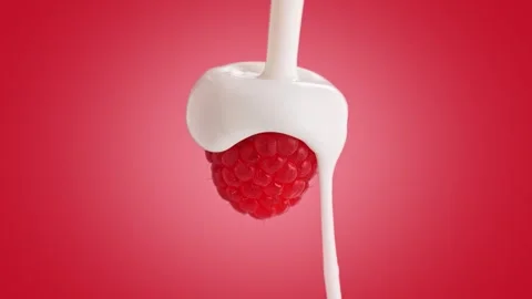 Yogurt Pouring from Top over a Raspberry on Pink Background in Slow Motion Stock Footage 274355356