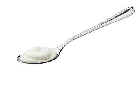 Yogurt on spoon Stock Photos