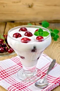 Yogurt thick with cherry on the board Stock Photos
