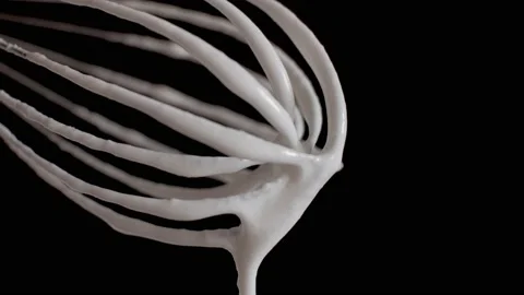 Yogurt whipped with a mixer flows down from the whisk Stock Footage 156935183
