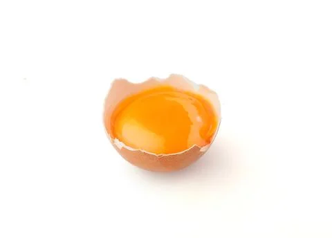 Yolk in the eggshell Stock Photos
