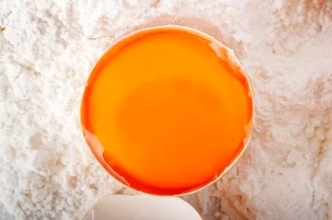 Yolk on flour background Stock Photos