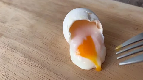 The yolk flows out of the boiled egg Stock Footage 185213104