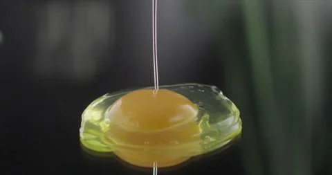 Yolk with protein falls on a mirror surface Stock Footage 198344782