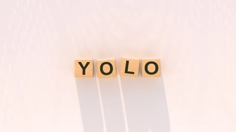 YOLO You Only Live Once Acronym on Wooden Letter Blocks 3D render animation Stock Footage 336563587