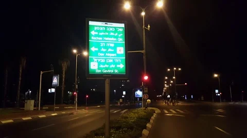 Yom Kippur evening 2016, Rokach road, street sign, people ride bikes, Tel-Aviv Vídeos de archivo 80228453
