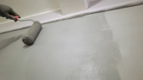Yong painter, builder paints a wall gray, closeup, repair Stock Footage 119210084