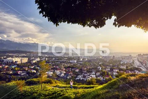 Yong woman at sunset city view Stock Photos