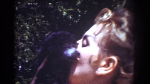 YORBA LINDA CALIFORNIA USA-1962: Blonde Woman Giving New Black Puppy Kisses In Stock Footage 121294537