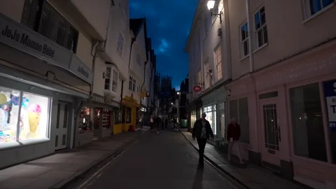 York Minster cathedral through the dark city streets past people and shops 動画素材 278218913