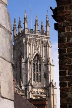 York minster seen between two buildings with blue sky Stock Photos
