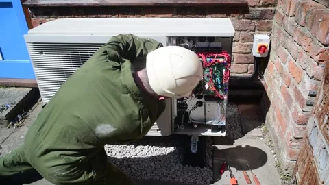York,england,12th June, 2025 engineer installing air source heat pump Stock Footage 310779532