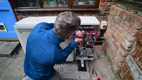 York,england,june/14/2025 engineer installing air source heat pump Stock Footage 311235591
