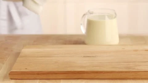 Yorkshire pudding batter being poured into a muffin tin Stock Footage 24672696