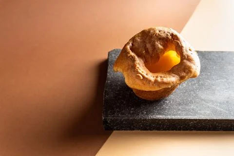 Yorkshire pudding on a brown background. Stock Photos