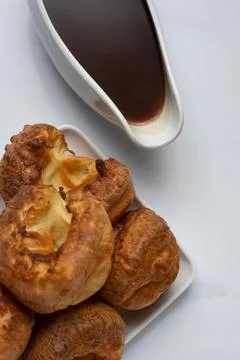 Yorkshire Pudding stack top down with gravy boat Stock Photos