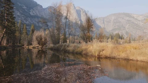 Yosemite Tilt Up to Mountains from River Stock Footage 101445412