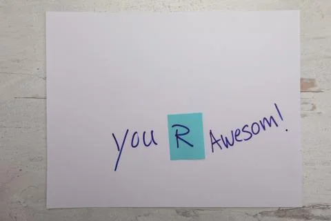 You are awesome message written on white paper on wooden backdrop Stock Photos