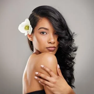 You are capable of amazing things. a beautiful young woman posing with a flower Stock Photos