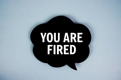 You Are Fired text with speech bubble on blue background Stock Photos