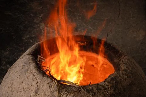 Before you bake bread in the clay oven, you have to make a fire Stock Photos