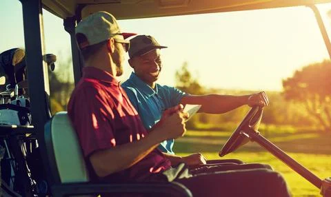 You better read through all the rules this time...two golfers riding in a cart Stock Photos