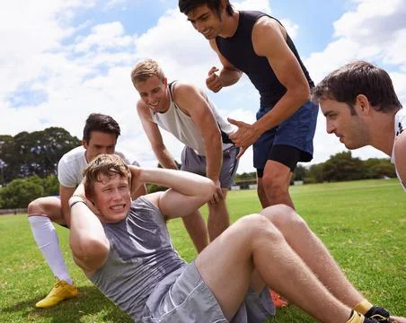 You can do it, bro. a young man being encouraged by his friends while he does Stock Photos