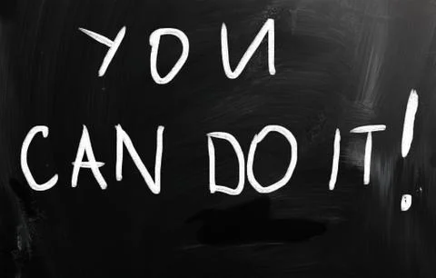 "you can do it" handwritten with white chalk on a blackboard Ilustración de archivo
