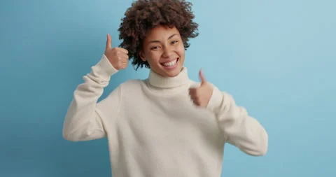 You can do it. Positive dark skinned woman raises thumbs up agrees with Stock Footage 143625266