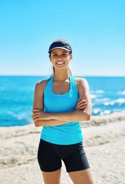 You can do whatever you put your mind to. a sporty young woman out on the beach Fotos de archivo