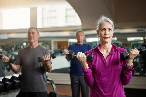 You can get old or you can get fit. a senior group of woman and men working out Stock Photos