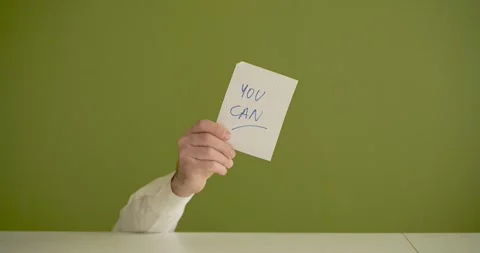 You Can   - The man's mini picks up a sheet where it is written Stock Footage 267089956