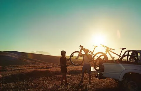 You cant be sad while riding a bicycle. a pair of adventurous mountain bikers Fotos Stock