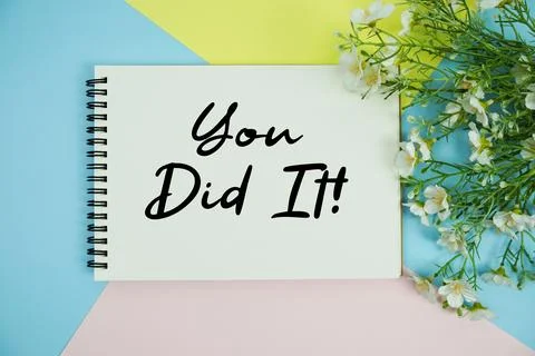 You Did It! text written on notepad with flowers decorations flat lay on mu.. Stock Photos