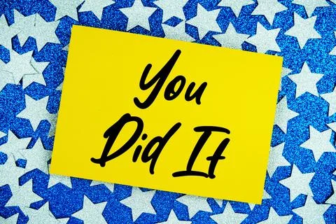 You Did It text written on paper card with star glitter on blue background Stock Photos