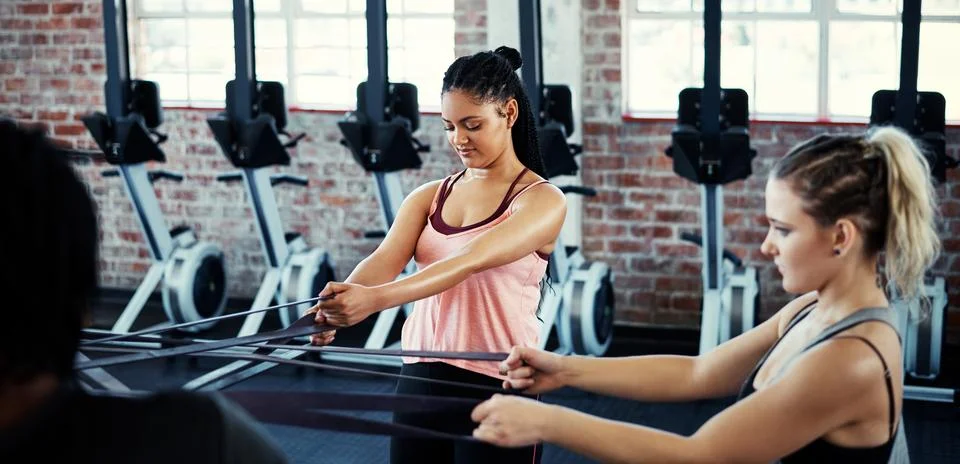 You earn your body. women working out with resistance bands. Stock Photos