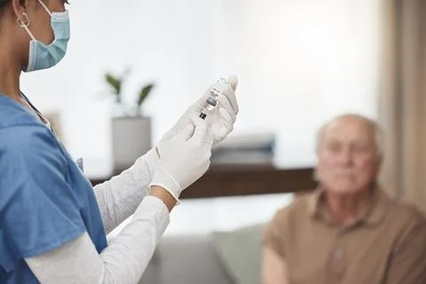 You have nothing to be afraid of. a young nurse giving an elderly man the Foto stock