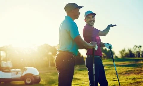 You learn something new every day. two friends playing a round of golf out on a Stock Photos