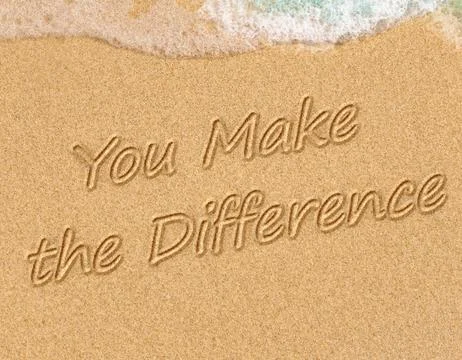 You Make the Difference on the sand on the beach with the sea washing up th.. Stock Photos