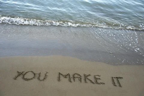 You make it  written in the sand on the beach with the sea washing up the sho Stock Photos