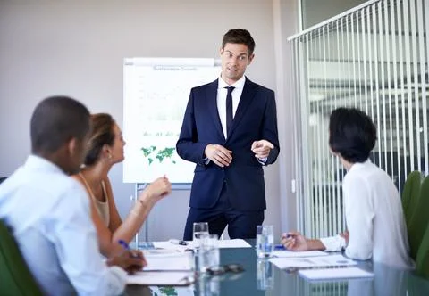 You make a valid point. Shot of a businessman presenting data during a boardroom Stock Photos