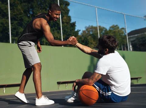 You played so well dude. Shot of two sporty young men shaking hands on a Stock Photos