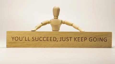 You'll succeed, just keep going. written on wooden surface. Personal developm Stock Photos