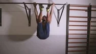 Youn Man Performing Abdominal Exercises On The Horizontal Bar At The Gym. Stock Footage