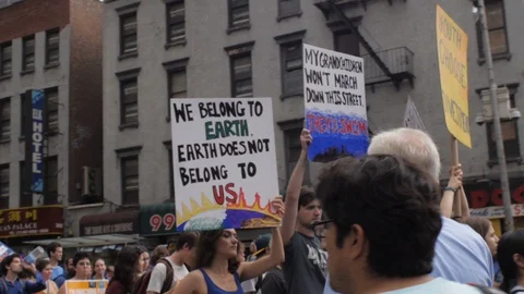 Young 20 -30 something people carrying climate change signs at a protest in NYC Stock Footage 87787250