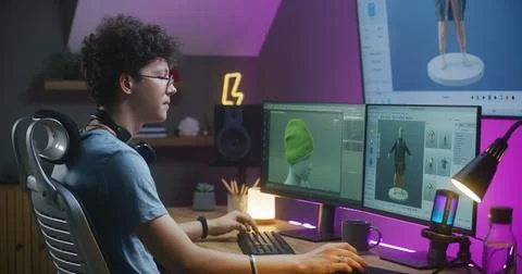 Young 3D designer creates clothes on PC using professional software Stock Photos