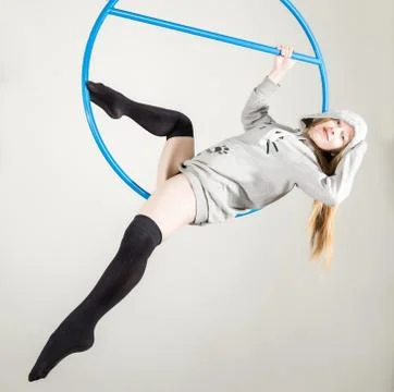 Young acrobat performs the acrobatic elements in the air. Aerial acrobat on a Photos