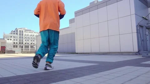 Young acrobatic guy jumping back somersault and dancing break dance outdoors Stock Footage 293839943