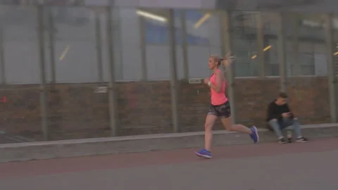 Young active athlete jogging in the city in the morning. Видео 132767097